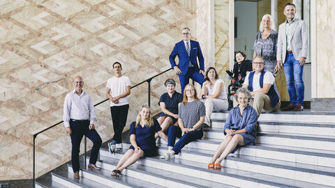 Jurymitglieder auf der Treppe sitzend